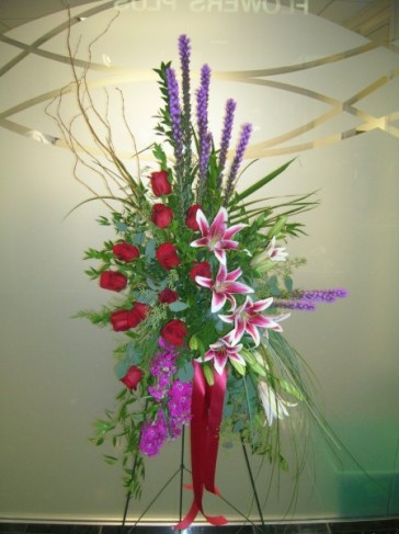 This funeral spray has been made from stargazer lilies red roses 