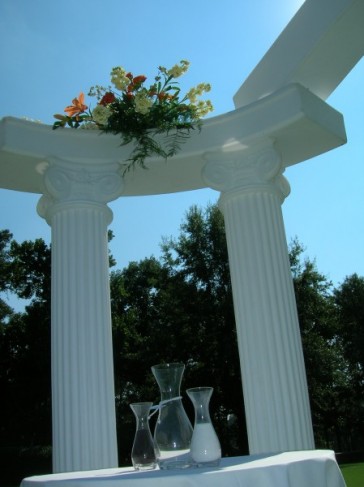 This wedding photo shows off some beautiful columns that have been decorated