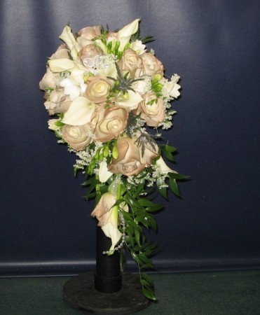  with champagne roses creates a special elegance for this bridal bouquet
