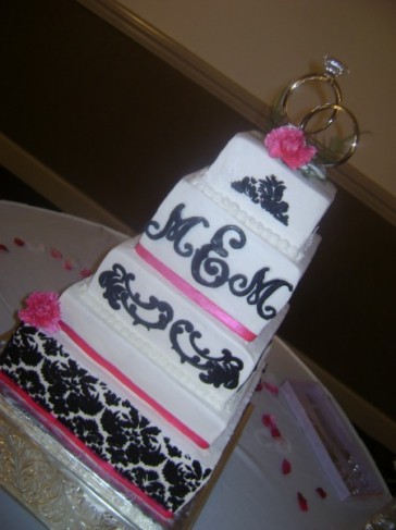 Black damask print decorates the majority of the bottom tier Hot pink 