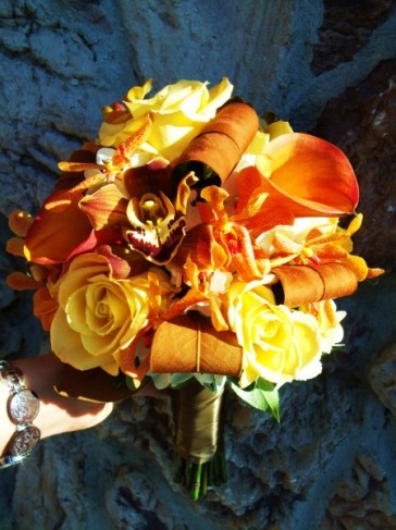This wedding photo shows a bridal bouquet in pretty fall colors