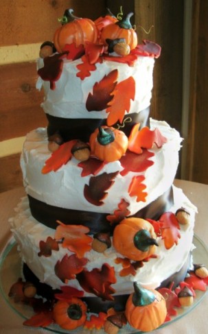 This three tier white wedding cake has a festive fall theme