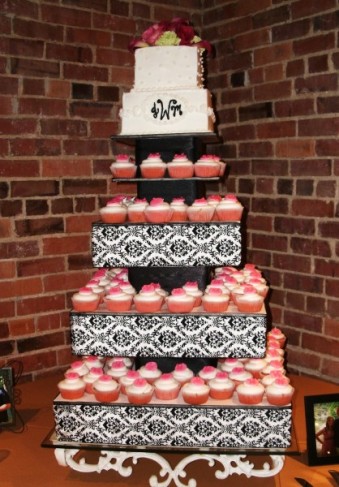 This wedding cake has been made from yummy pink and white cupcakes A black 
