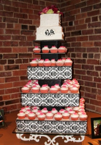 This wedding cake has been made from yummy pink and white cupcakes A black