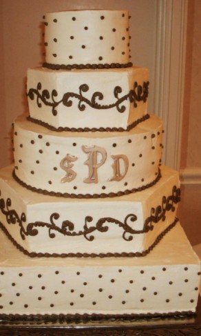 This wedding cake has a mixture of geometric designs