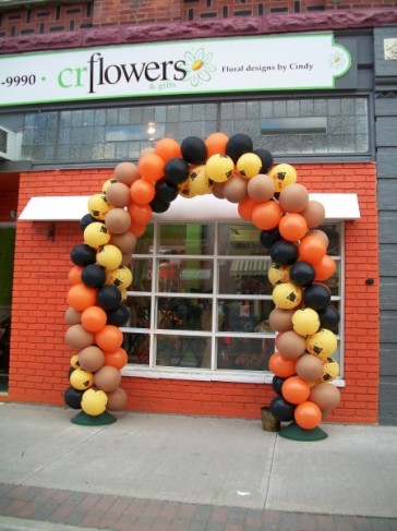 This fall balloon arch has been made from orange yellow black 