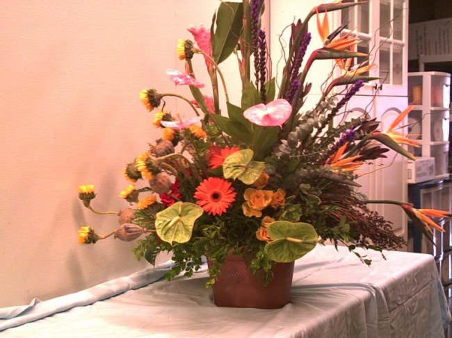 These reception flowers are a tropical mix of orange daisies sunflowers 