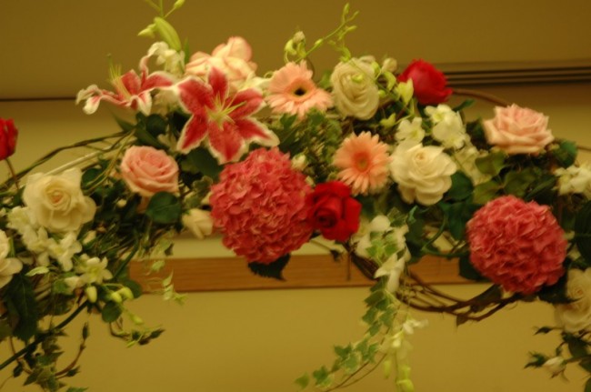 The flowers for this wedding arch are a beautiful combination of pink and 