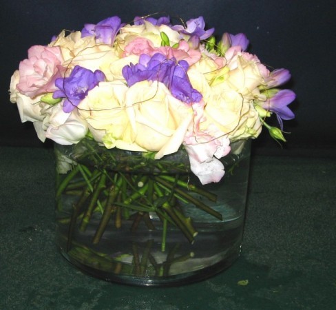 Low table arrangement in a modern glass container is fantastic for chic 