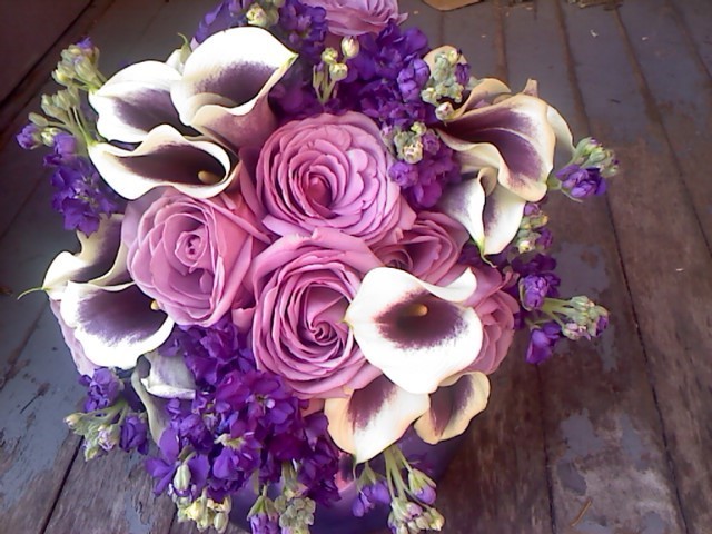 This pretty purple bridal bouquet was created with lovely lavender roses