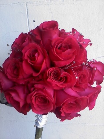 This lovely hot pink rose wedding bouquet is elegant with a small touch of