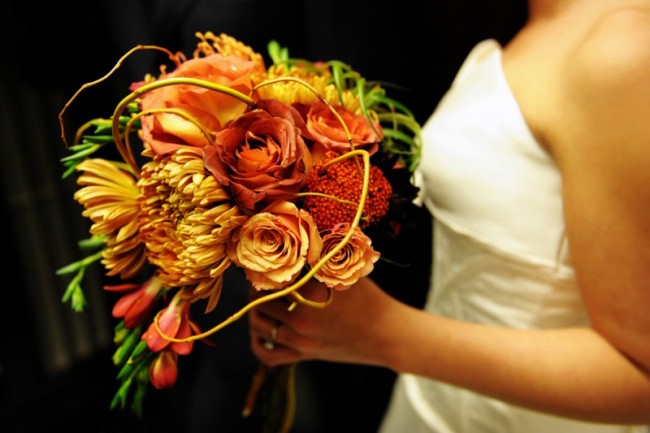This photo captures the bride 39s absolutely stunning orange bridal bouquet