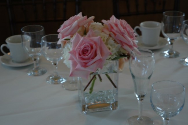 A beautiful rose and hydrangea wedding reception centerpiece would look