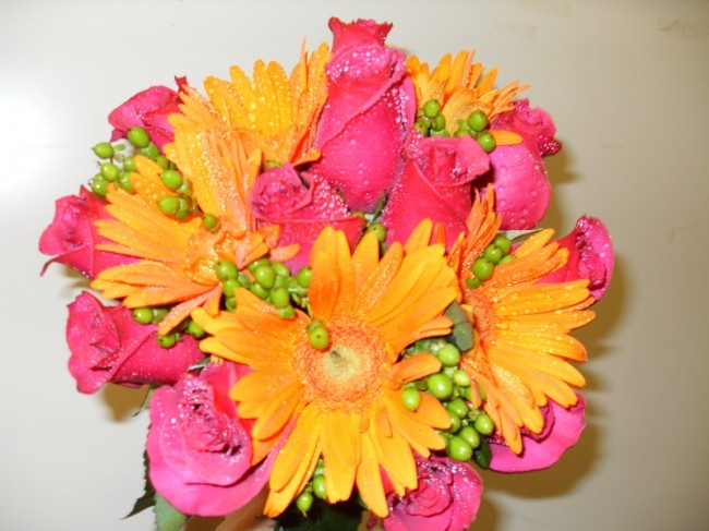 This wedding bouquet is so colorful featuring gorgeous pink roses and orange