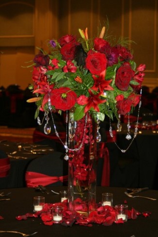 This photo captures a beautiful tall wedding reception centerpiece that is 