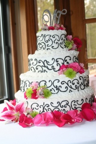 Pink green wedding flowers accent the cake perfectly