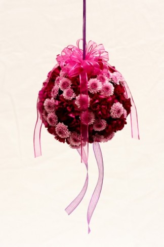 These wedding flowers can serve as a kissing ball for the flower girl or pew