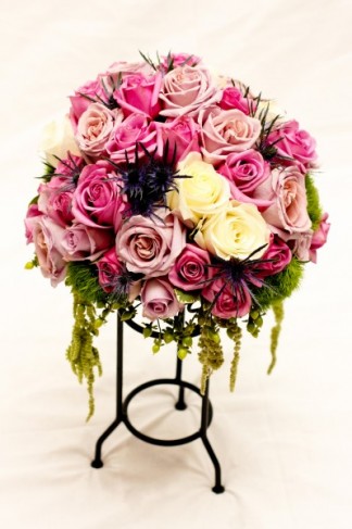 This beautiful rose centerpiece features beautiful pink lavender and cream 