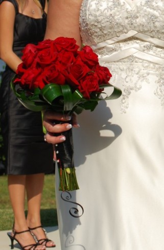 This bride is holding a gorgeous red rose wedding bouquet which provides a 