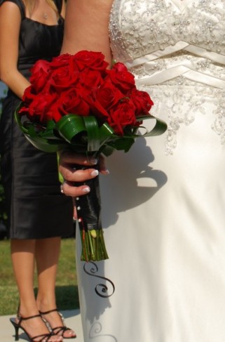 This bride is holding a gorgeous red rose wedding bouquet which provides a