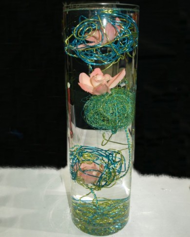 This unique wedding centerpiece features submerged orchids with wire 