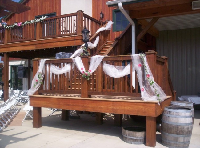 Beautiful white tulle creates lovely wedding ceremony decorations with pink 