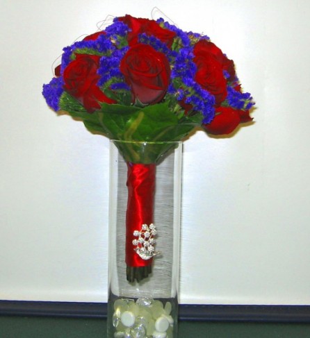 This beautiful red blue wedding bouquet is hand tied with a beautiful 