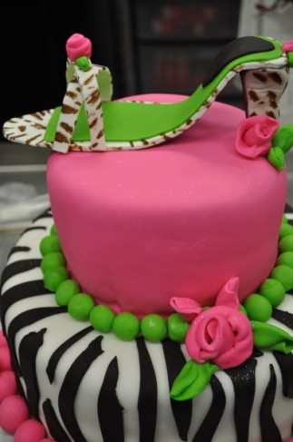 This 2 tiered party cake features a fun zebra design, pink and green accents 