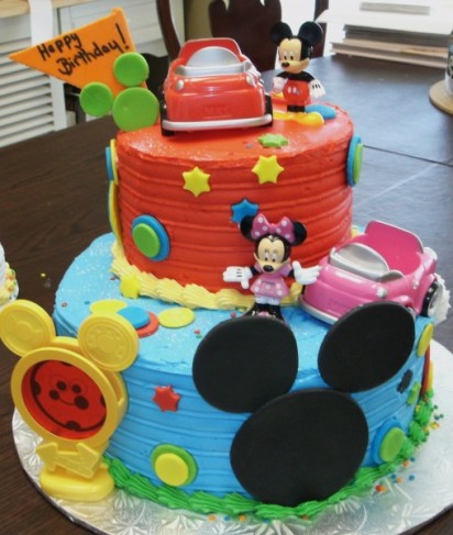 This 2 tiered birthday cake features red and blue icing with Mickey designs 