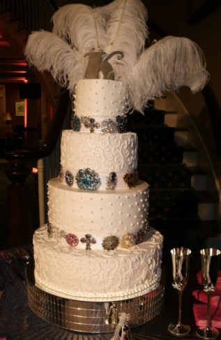 This 4 tiered wedding cake features intricate designs, fun accents and a 