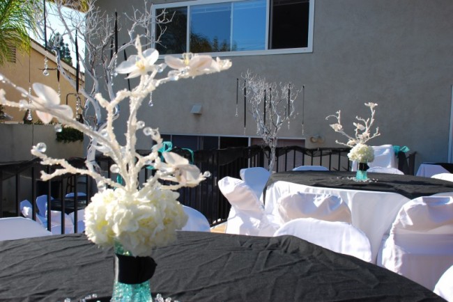 centerpieces features white hydrangeas with turquoise and black accents