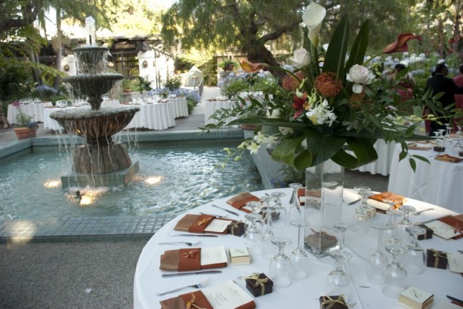 This elegant wedding reception features gorgeous reception centerpieces on 