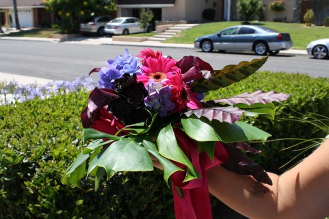 This beautiful wedding bouquet features pink and purple flowers with green