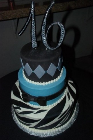 This birthday cake features a zebra print bottom with blue accents to make 