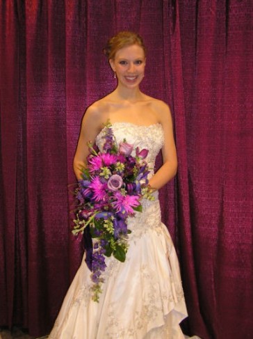 This cascading bridal bouquet was created with deep plum and hot pink 