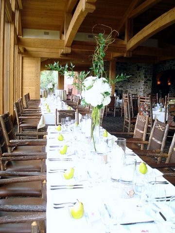 This lovely wedding reception features a beautiful table setting and an 