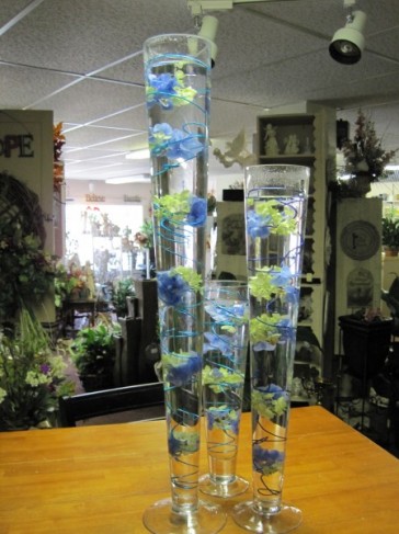 A wonderful wedding reception centerpiece that features submerged blue and