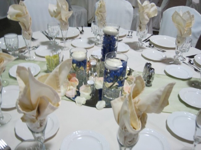 This wedding reception table features submerged delphiniums 