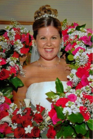 Bride's wedding bouquet in red roses and white mini callas and stephanotis