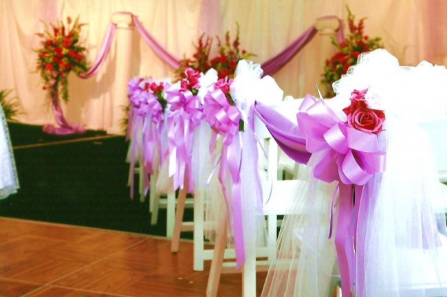 This wedding ceremony is adorned with beautiful white tulle pink ribbon and