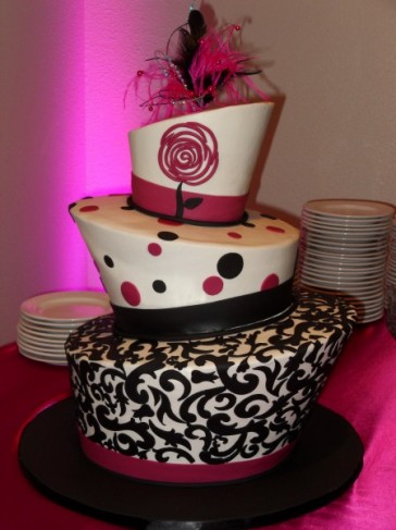 This fun pink black wedding cake features 3 Topsy turvy tiers with fun 