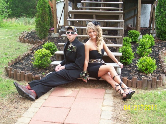 She wears an amazing black prom dress with a camo sash and matching shoes 