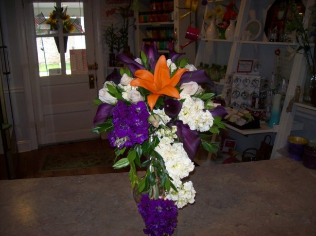This beautiful bridal bouquet features a orange lily and is accented with 