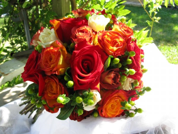 This gorgeous red and orange bridal bouquet features roses and hypericum