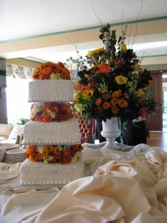 This 3 tiered wedding cake is decorated with gorgeous fall wedding flowers