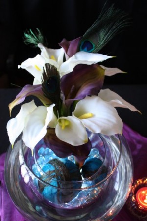 reception feather centerpiece is a great accent to the purple linens on