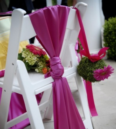 Draped with beautiful hot pink fabric these chairs are also decorated with