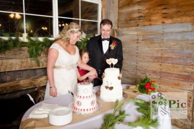Bride and Groom Gets Some Help in Cutting Cake