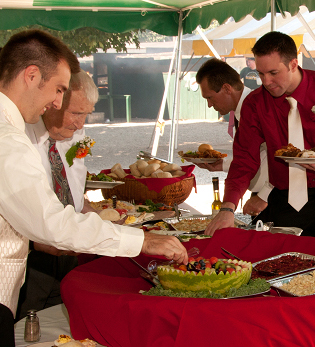 Guys Grabbing Food at Wedding Reception