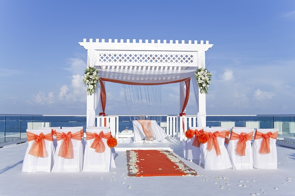 Stunning wedding ceremony setup in orange at the Azul Sensatori Hotel in Riviera Maya, Mexico